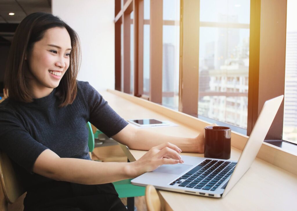 A woman in her laptop doing digital banking