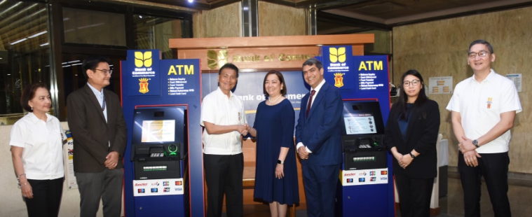 Michelangelo R. Aguilar of BankCom shaking hands with Marga Estabanlar of NCR in the presence of other bank executives