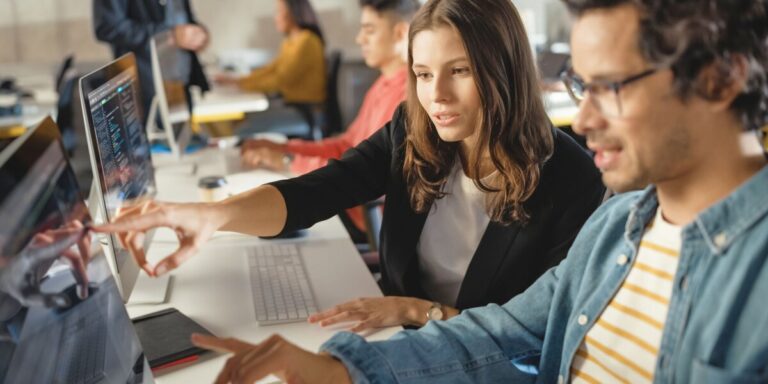 A man and a woman undertaking learning courses under the AWS Build Program