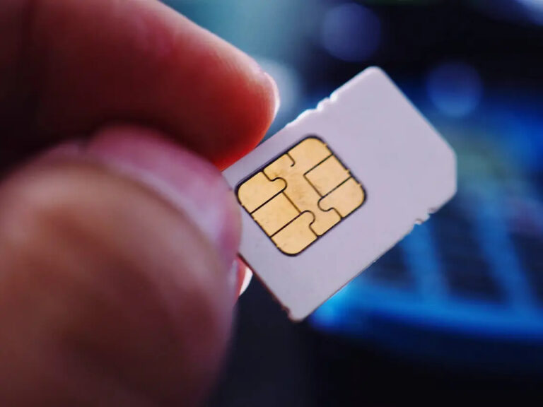 A man holding an unregistered SIM card