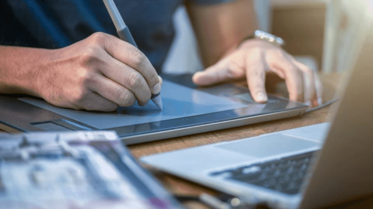 A man writing on his tablet PC