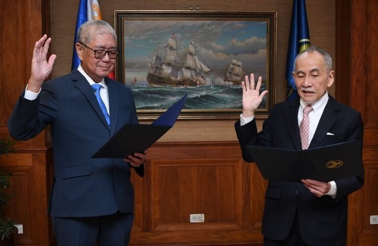 Romeo Bernardo while being sworn in by the BSP chief as a new member of the Philippine Monetary Board