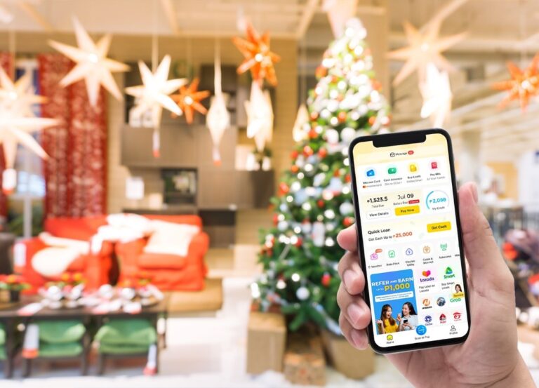 A mobile phone with Mocasa app and a Christmas tree in the background