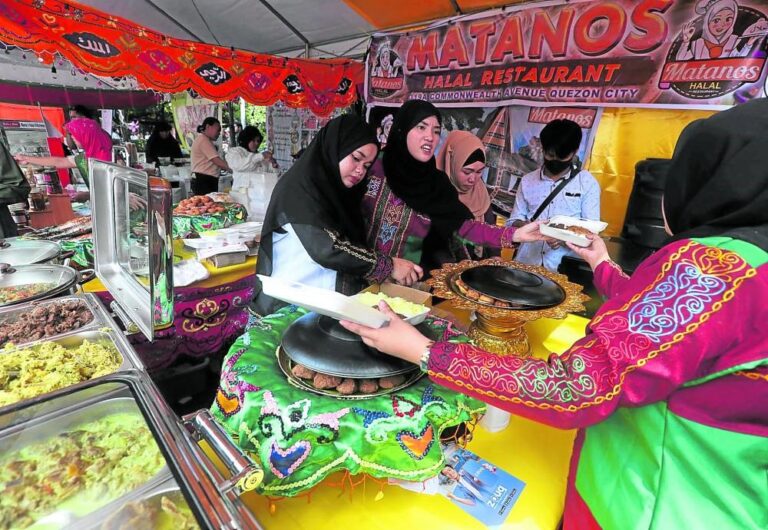 Women clad in their traditional Muslim attire buy goods at a Halal-certified business establishment