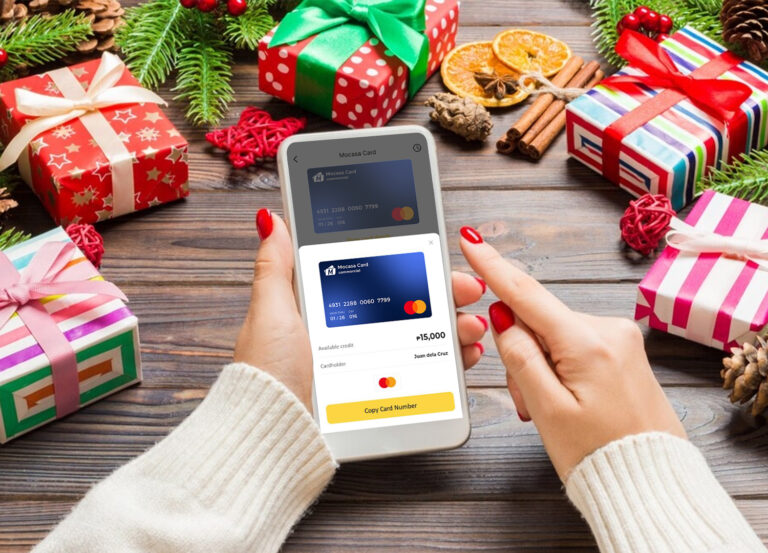 A girl holding a mobile phone, ready to buy online holiday presents through the Mocasa app