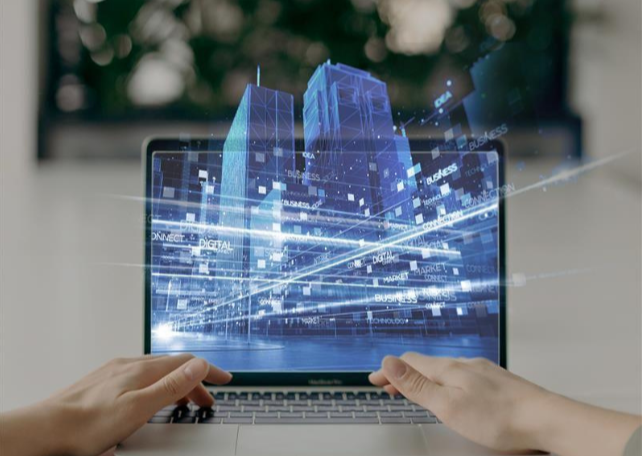 A laptop screen showing CGI of a two-tower building