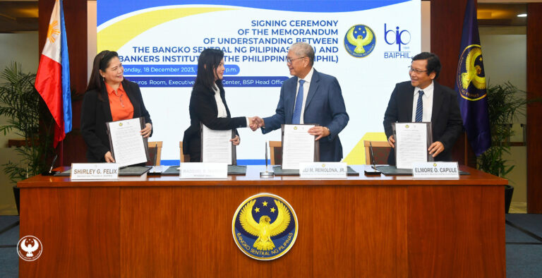 BSP Governor Eli M. Remolona, Jr. and BAIPHIL President Racquel B. Mañago while shaking hands after signing a memorandum of understanding (MOU) covering collaboration on productivity enhancements for banks through research, information, and education