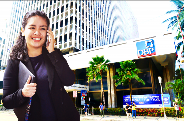 A woman in front of BDP building while holding a mobile phone