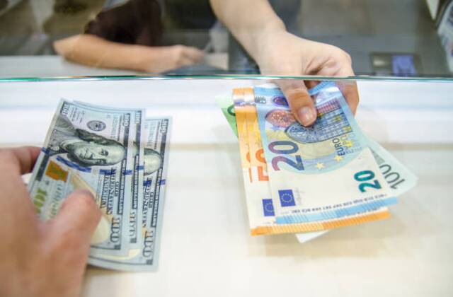 Photo showing the exchange of US dollars into Philippine Pesos