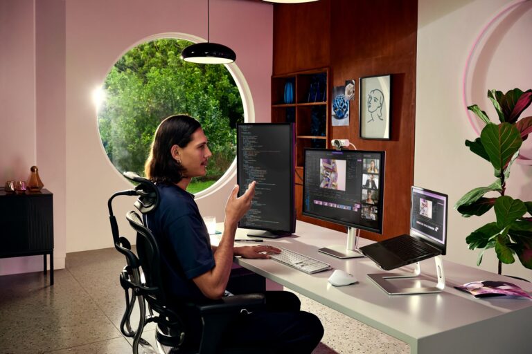A man in front of his PC equipped with the new Logitech MX Brio Ultra HD 4K Webcam