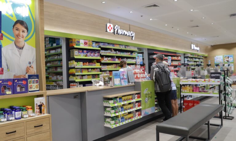 A senior citizen buying medicine at a Watsons pharmaceutical store