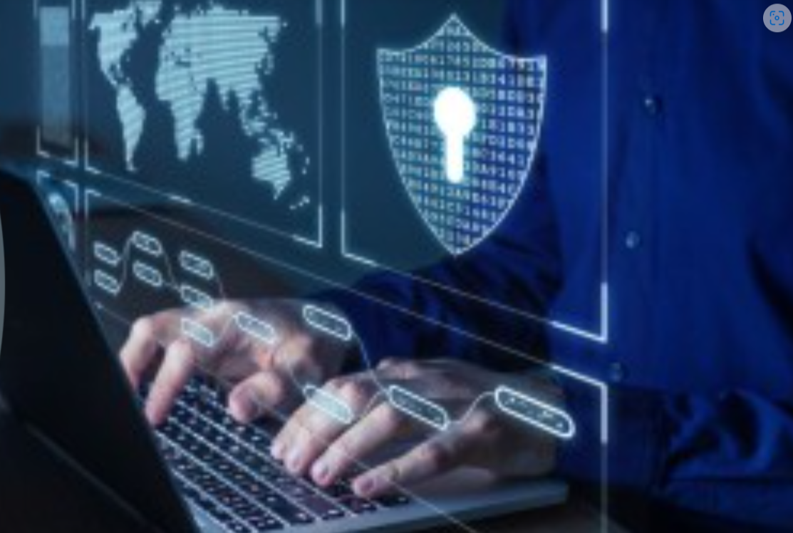 A man typing on his laptop to show the dangers of digital fraud as the country celebrates Cybersecurity Awareness Month