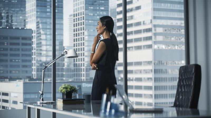 A woman looking out the window of her lavish condo