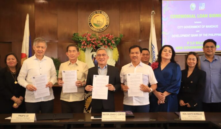 Michael O. De Jesus, president and CEO of DBP, together with Mandaue City officials during the ceremonial loan-signing agreement