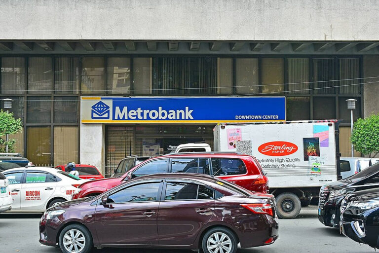 Facade shot of a Metrobank with cars in fromt