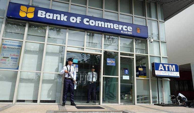 Security guards in front of a Bank of Commerce branch in Molito
