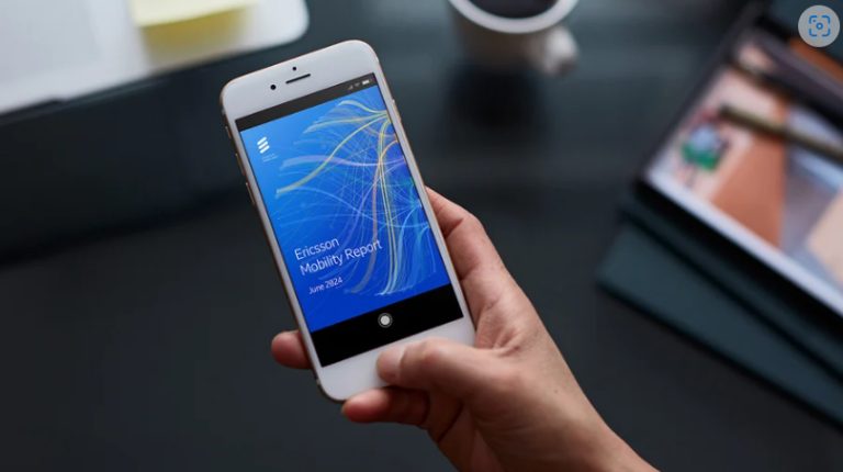 A mobile phone showing the cover page of the 2024 Ericsson Mobility Report about 5G subscriptions globally