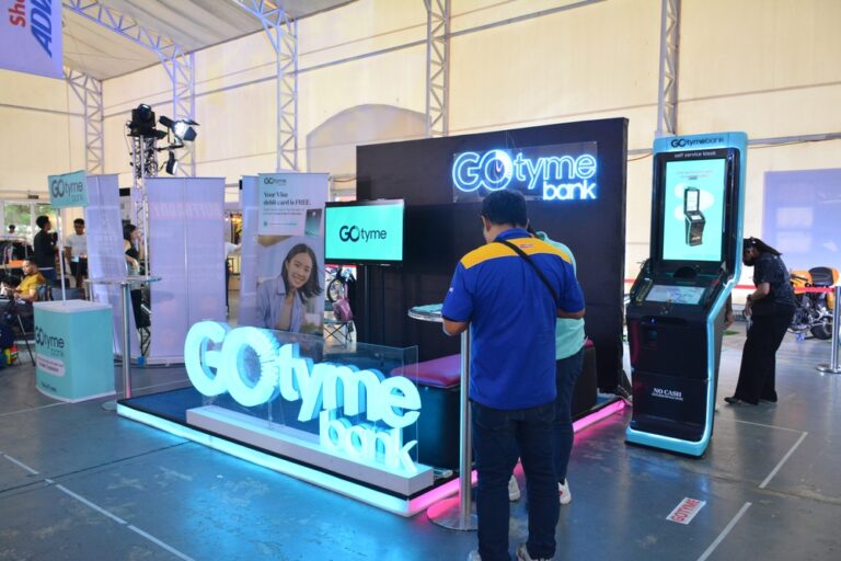 A man about to enter a GoTyme Bank exhibit booth