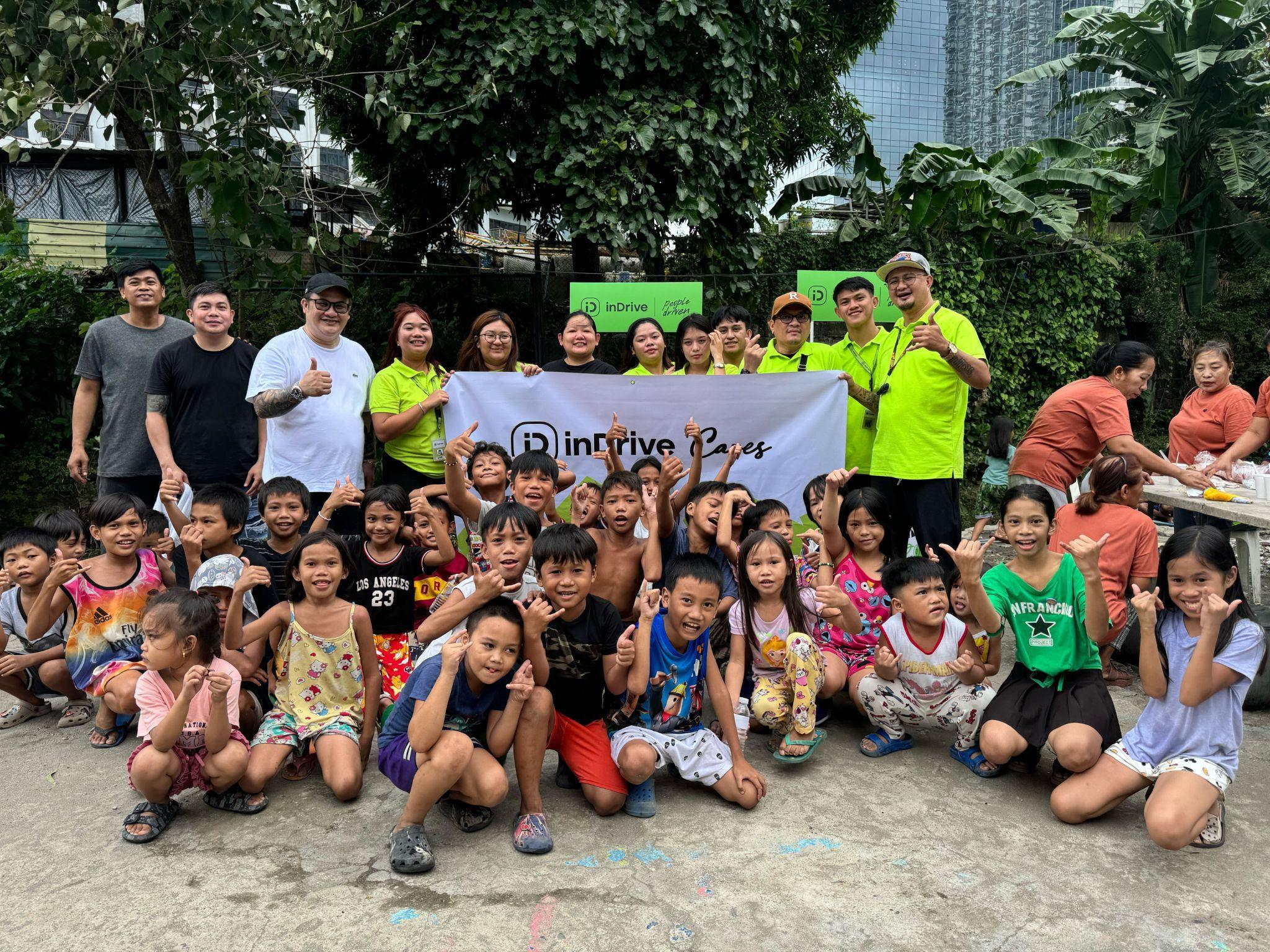 Executives of inDrive together with the children beneficiaries from a community in Sitio San Roque