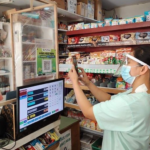 A female merchant accepting digital payment as the SEC extends MSME registration and filing fee discounts