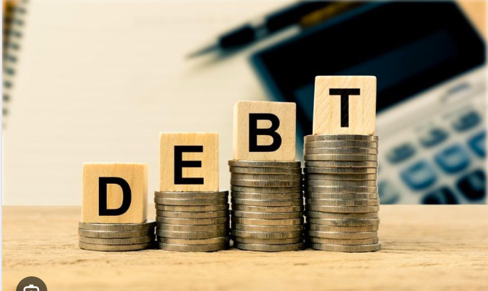 The Monetary Board of the BSP has greenlit a total of US$3.81 billion in foreign borrowings by the public sector, as illustrated by a pile of coins with the word 'debt' on top