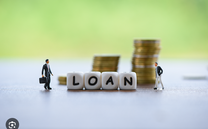 Bank lending and FCDU loans drop by 2.7% in Q2 of 2024, as illustrated here by two miniature men and the word loan in blocks