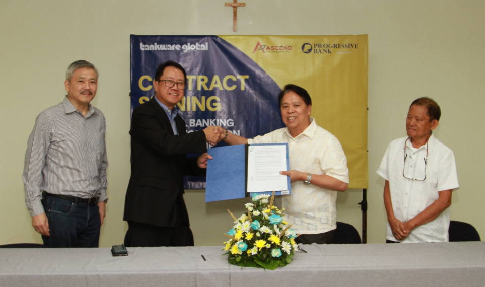 Progressive Rural Bank and Bankware Asia executives shake hands during the signing of agreement between the 2 parties
