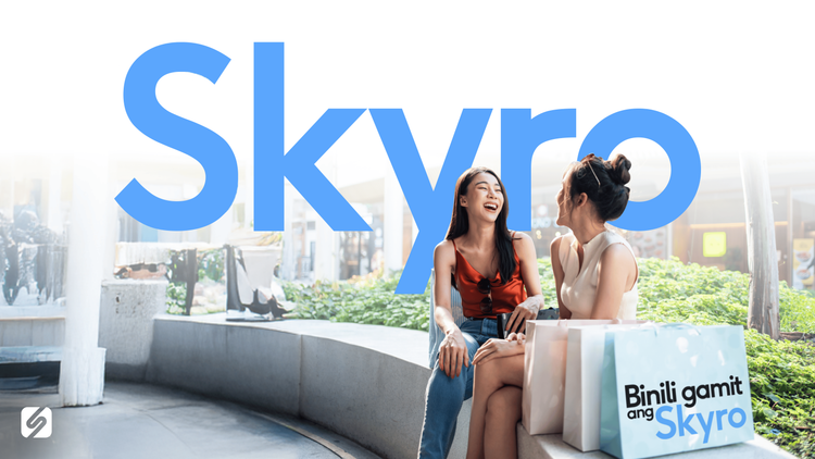 Two women talking with the Skyro logo in the background