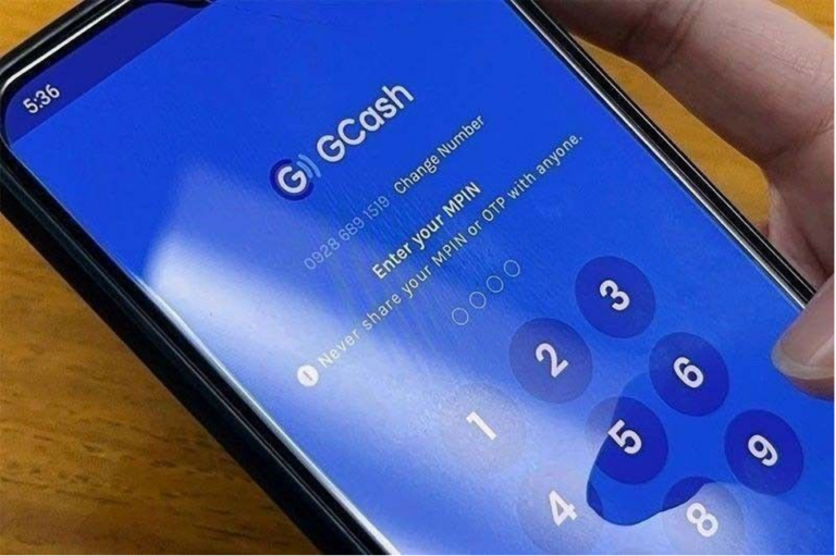 Photo shows a mobile phone with the GCash Cash-in fees app