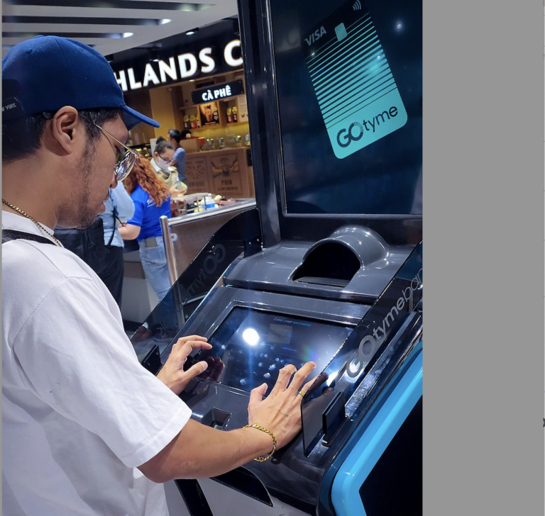 GoTyme Bank targets 9 million users in 2025, and this photo of a man using the GoTyme Bank ATM is proof it will succeed