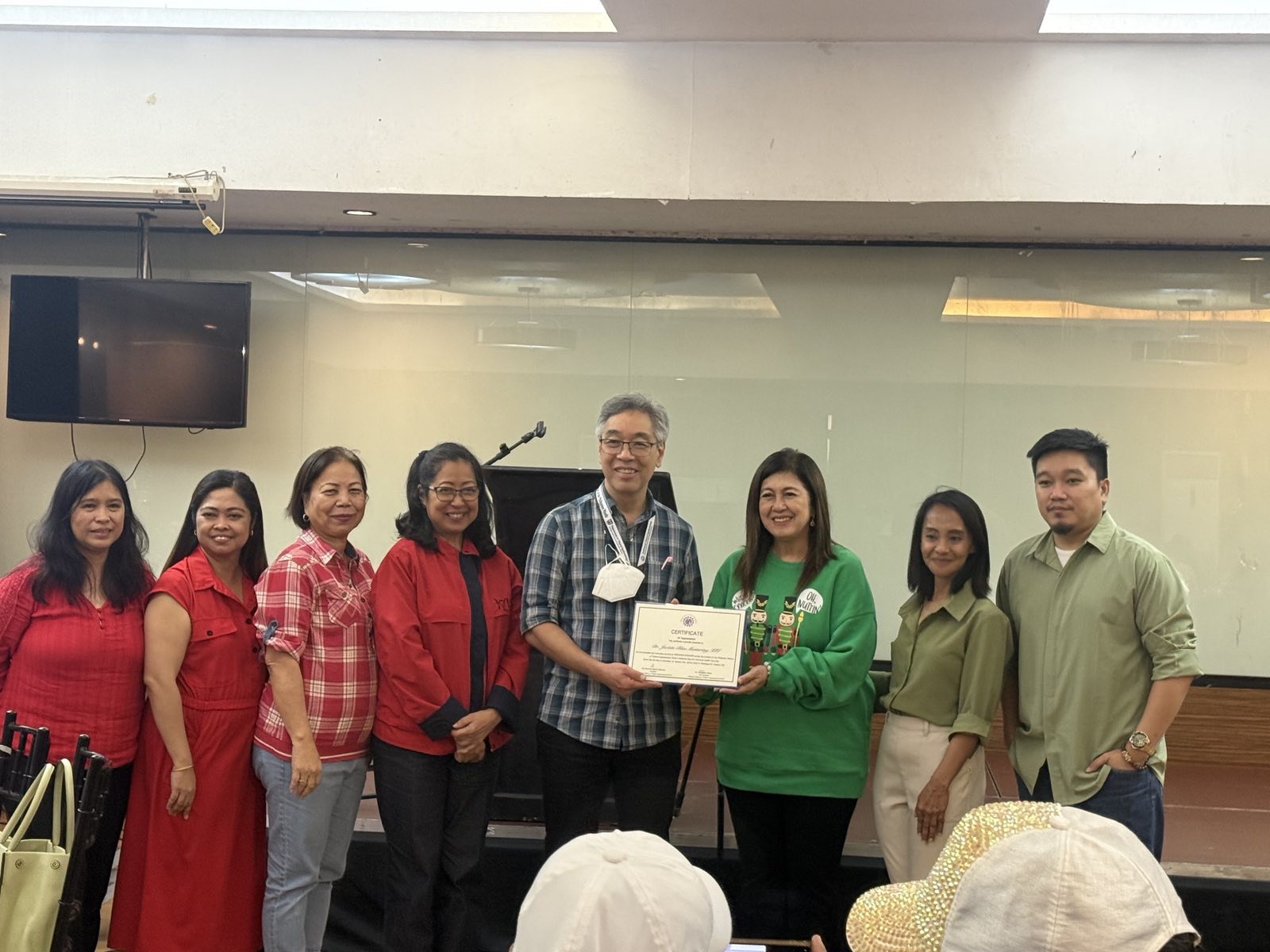 Photo shows Dr. Mantaring of PAPO while receiving a Certificate during an event that discussed critical updates on Universal Health Care (UHC) law