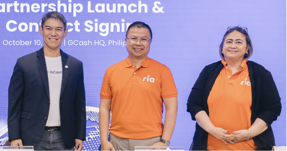Paul Albano of GCash together with Steve Peregrino and Eileen Roque, both of Ria Money Transfer, during the signing