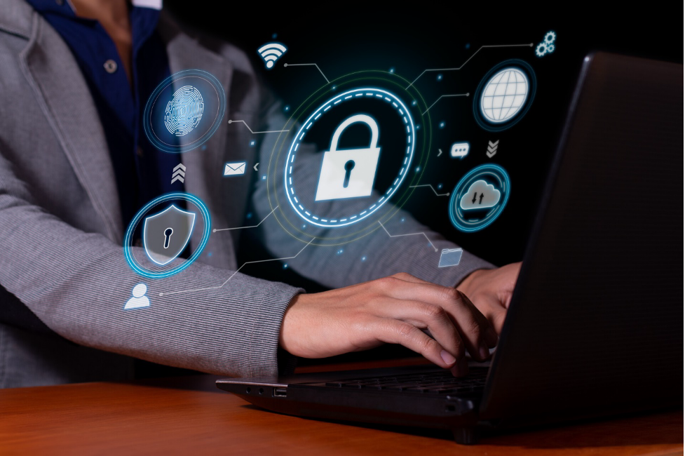 Image of a man typing on his laptop to show how AI is revolutionizing the cybersecurity threat landscape