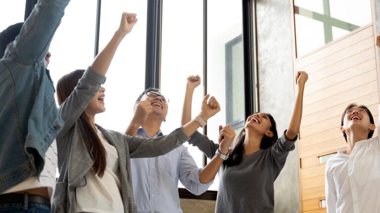 Photo of celebrating employees of ATRAM as the company rides the fintech wave to deliver stellar investment returns in 2024