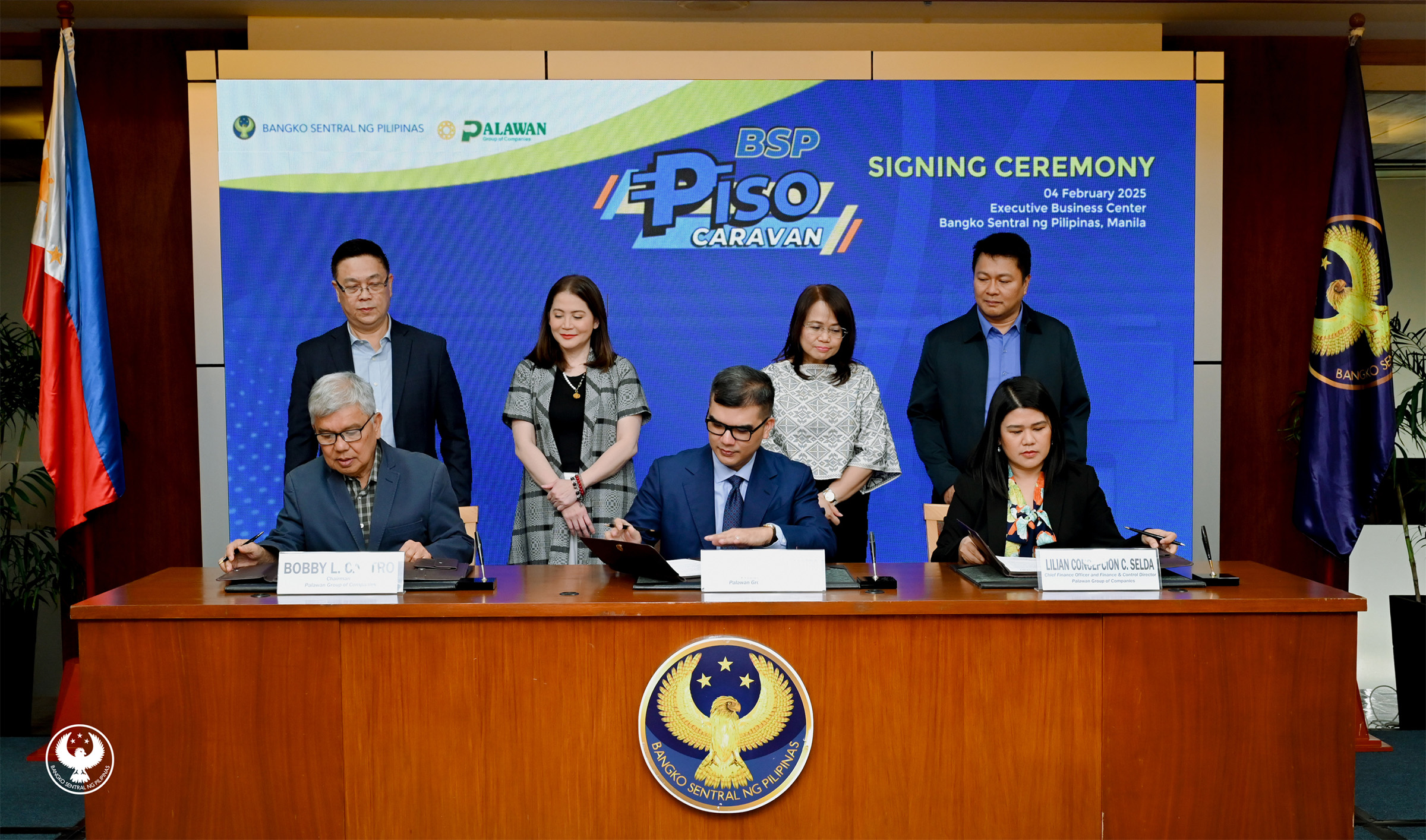 Executives of BSP and Palawan Group of Companies during the MOA-signing to formalize a partnership aimed at expanding the reach of BSP's Piso Caravan initiative