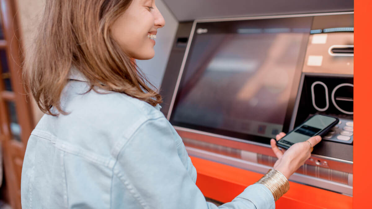 A woman doing cardless cash withdrawal from an RCBC ATM