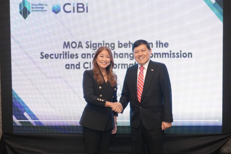 Pia L. Arellano (left), President and CEO of CIBI Information Inc., while shaking hands with Emilio B. Aquino, Chairperson of the SEC