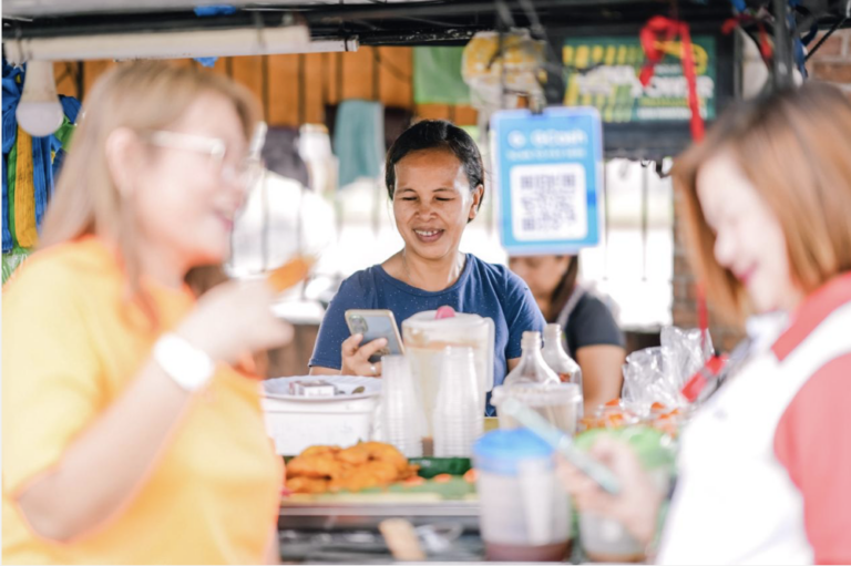Photo of a female vendor showing how e-wallet providers can fuel 'sari-sari' stores