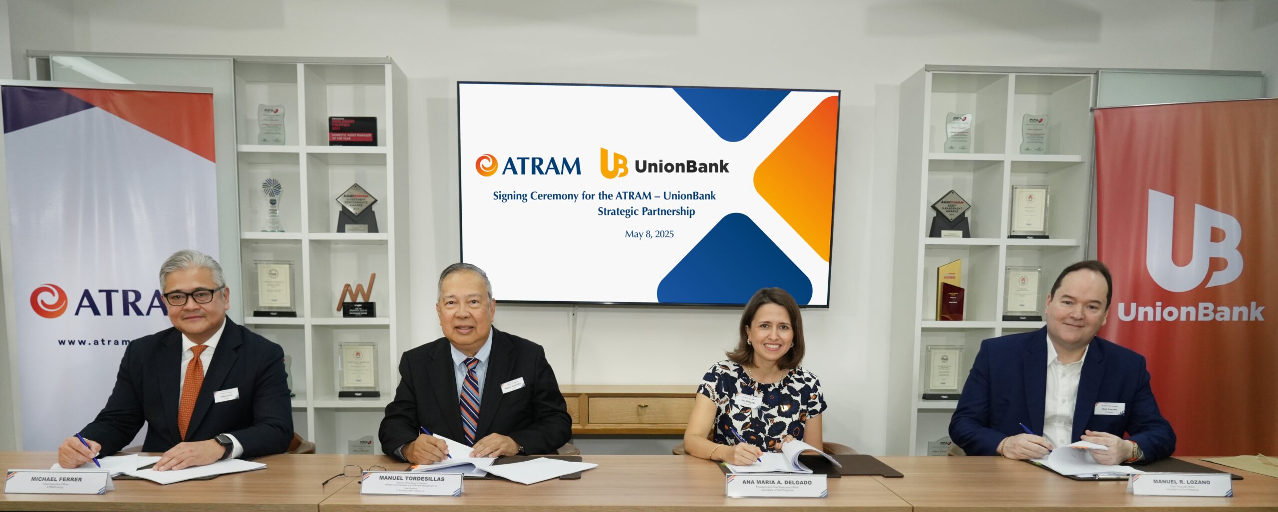 UnionBank and ATRAM executives while formalizing the partnership to enhance financial services