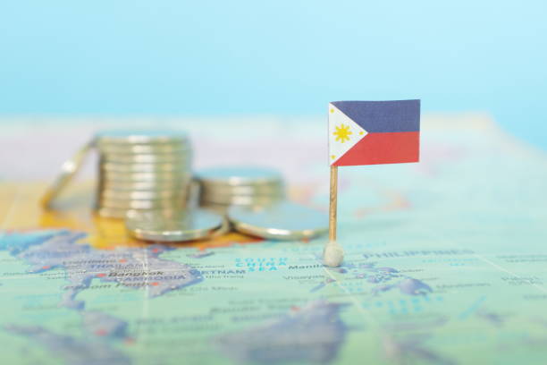 Backdrop of PH flag and coins to show how Filipino workers' remittances fuels our economic lifeline