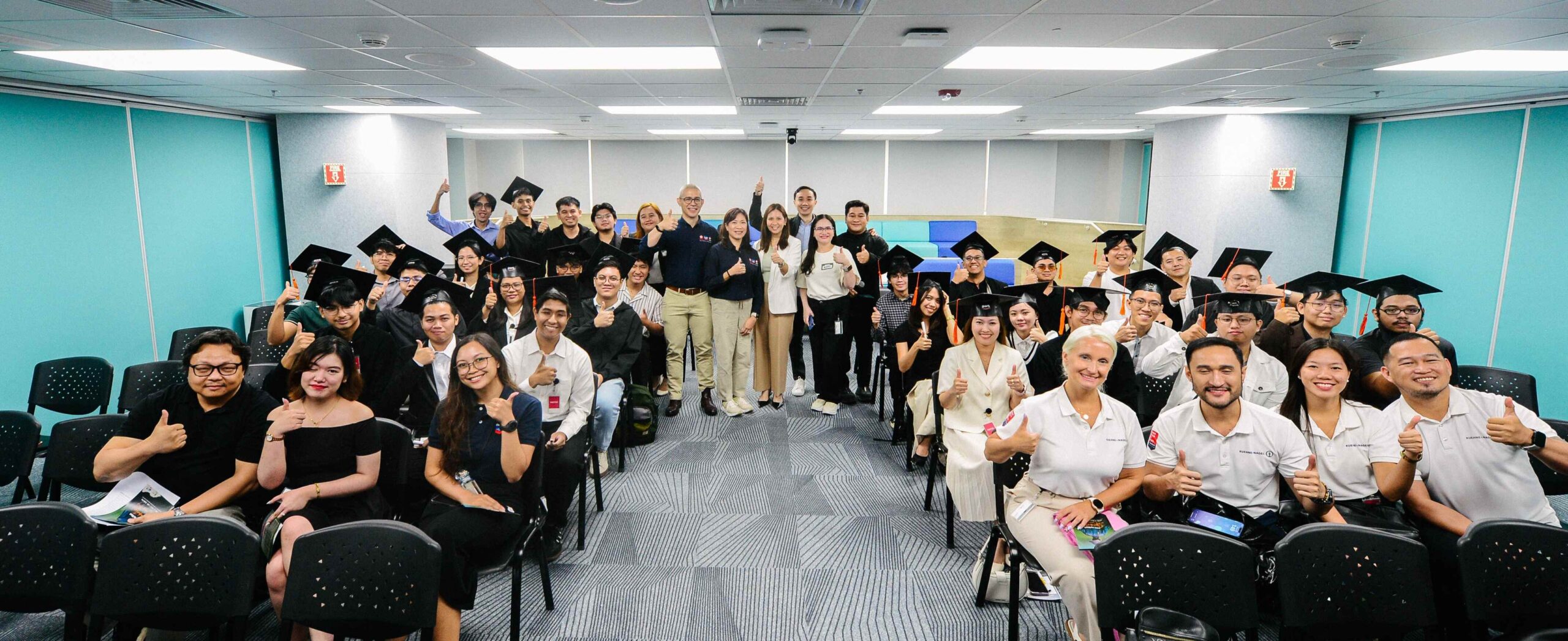 Executives from Chevron, Edukasyon.ph, AWS, and Job Partners, along with the graduates, gather after the graduation ceremony