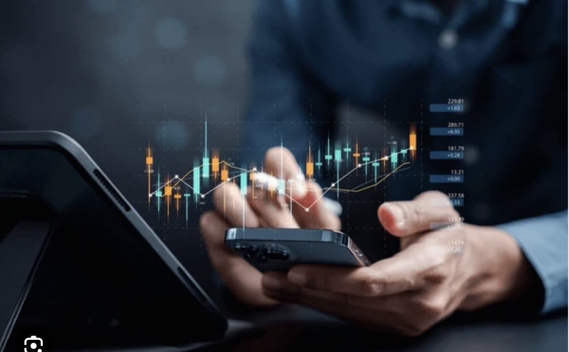 A man calculating BoP using a mobile phone as the BSP sees rate cut signaling accommodative stance amidst global headwinds