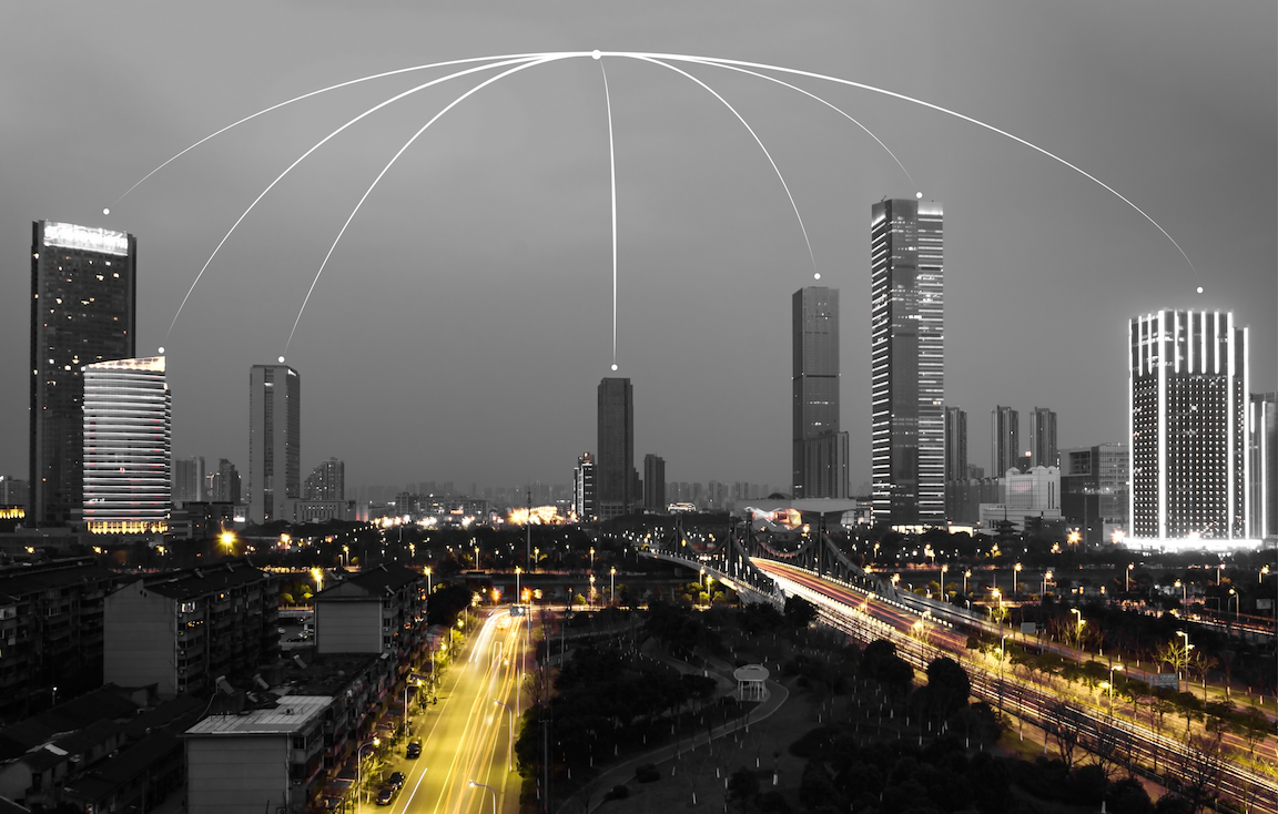 Inter-connected buildings and bright lights to illustrate how Bitget is expanding Starlink-powered PayFi islands initiative