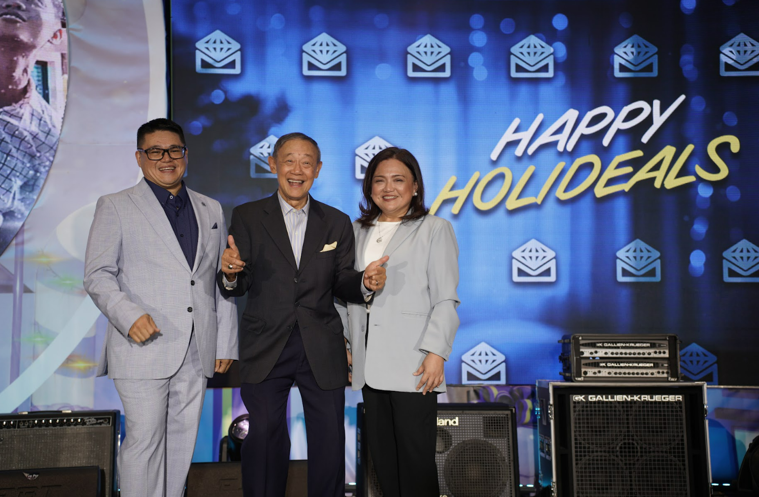 Metrobank's Peaches Cuenco (right), Head of the Consumer Lending Group, joins "King of Christmas Carols" Jose Mari Chan (center) to kick off the bank's "Happy Holideals" promo