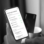 A hand holding a mobile phone with Maya's Black card as the payment company sets new security standards in credit card industry 
