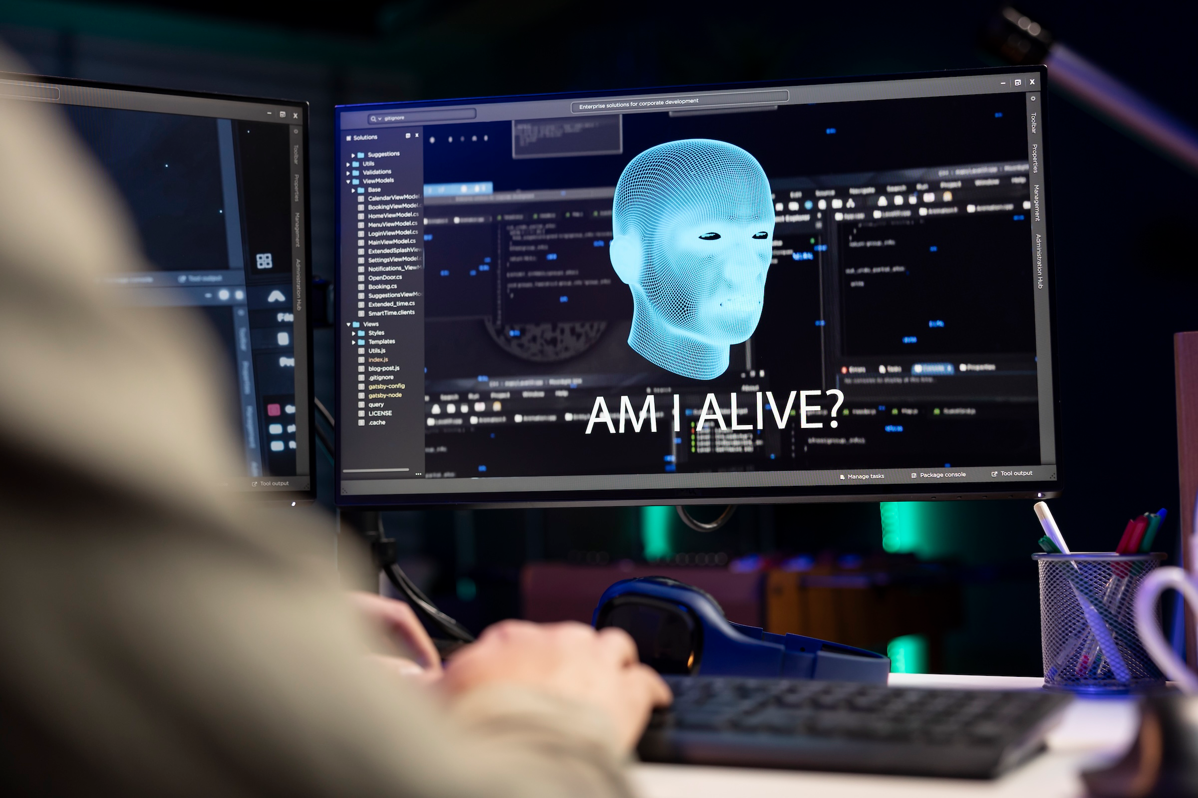 Image shows coding simulation of a robot head as it appears on a computer screen to highlight result of a Canva survey that says AI-assisted coding going mainstream