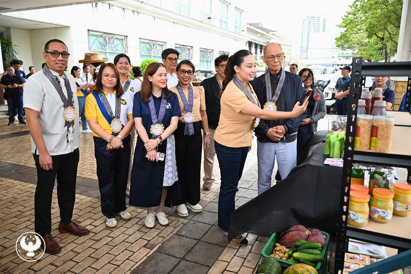 Top executives of BSP watch Iloilo Vice Governor Nathalie Ann F. Debuque as she attempts to pay a local merchant using QR Ph code during the Paleng-QR Ph Plus launch at the Iloilo Provincial Capitol