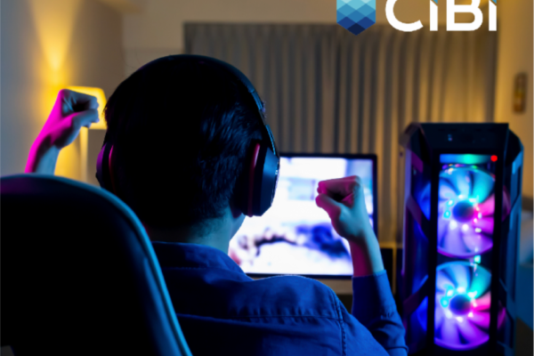 A man with headset pumps his fist in front of a monitor after reading a CIBI report about hiring fraud risks in the Philippine job market
