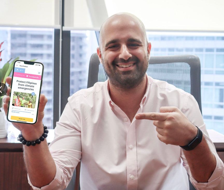 A smiling Dan Marogy, newly appointed CEO of UBx, UnionBank's fintech subsidiary, points to a handheld mobile phone