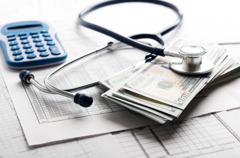 A stethoscope, a calculator and some cash is used to demonstrate how Fintech is expanding healthcare financing and microinsurance in rural PH